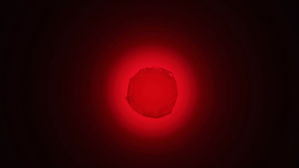 A glowing red gemstone surrounded by gentle red light on a dark background